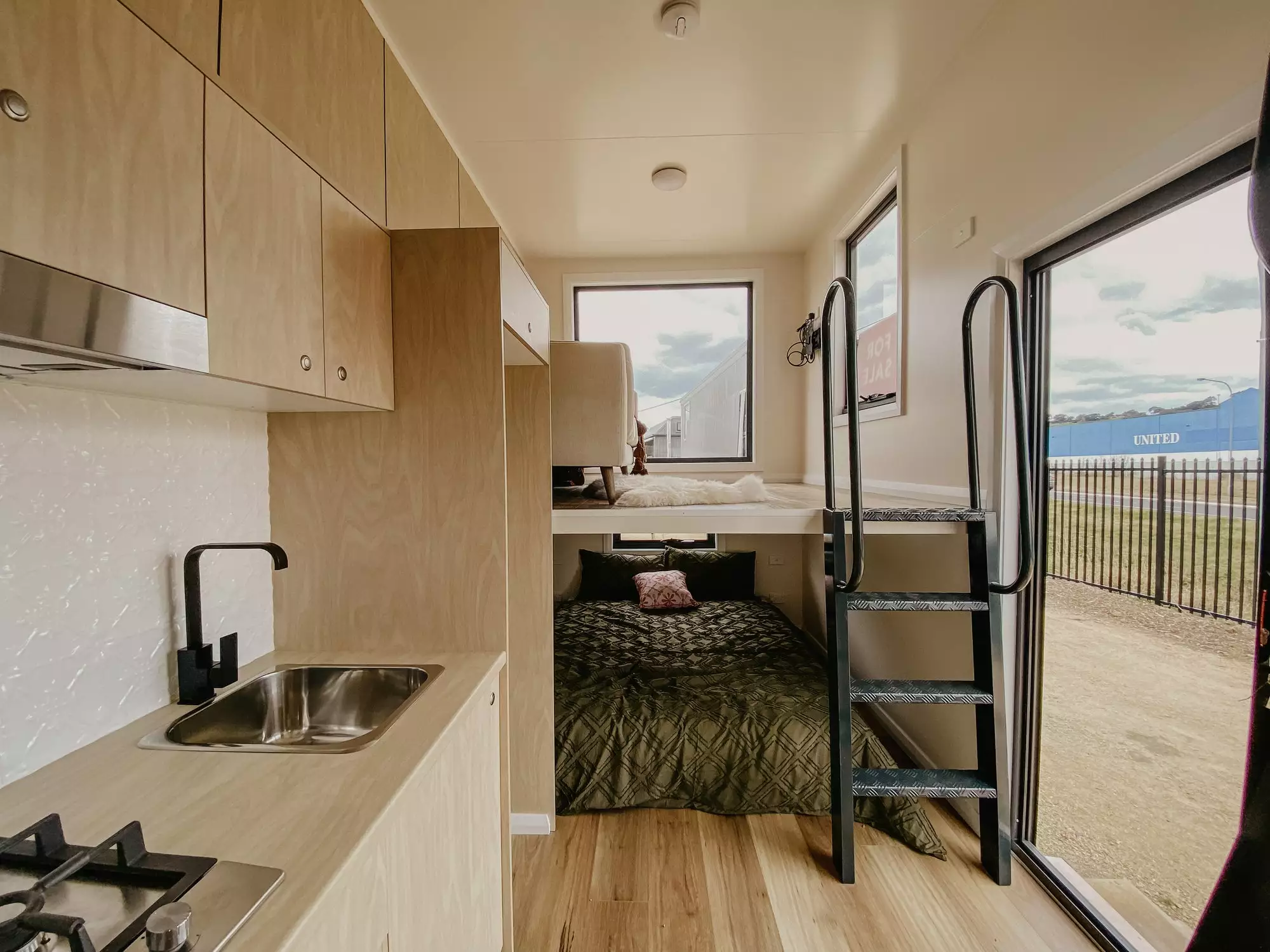 The Beau River Tiny House's "upside-down" interior layout features a raised living room