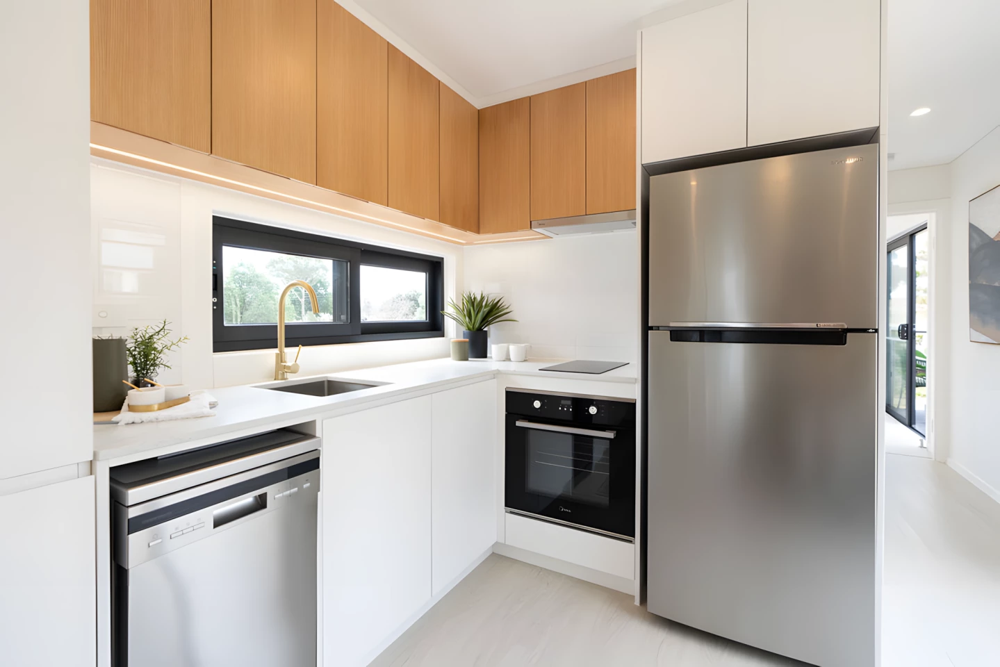 The Kookaburra's kitchen includes an induction cooktop, an oven, a sink, a dishwasher, and a fridge/freezer