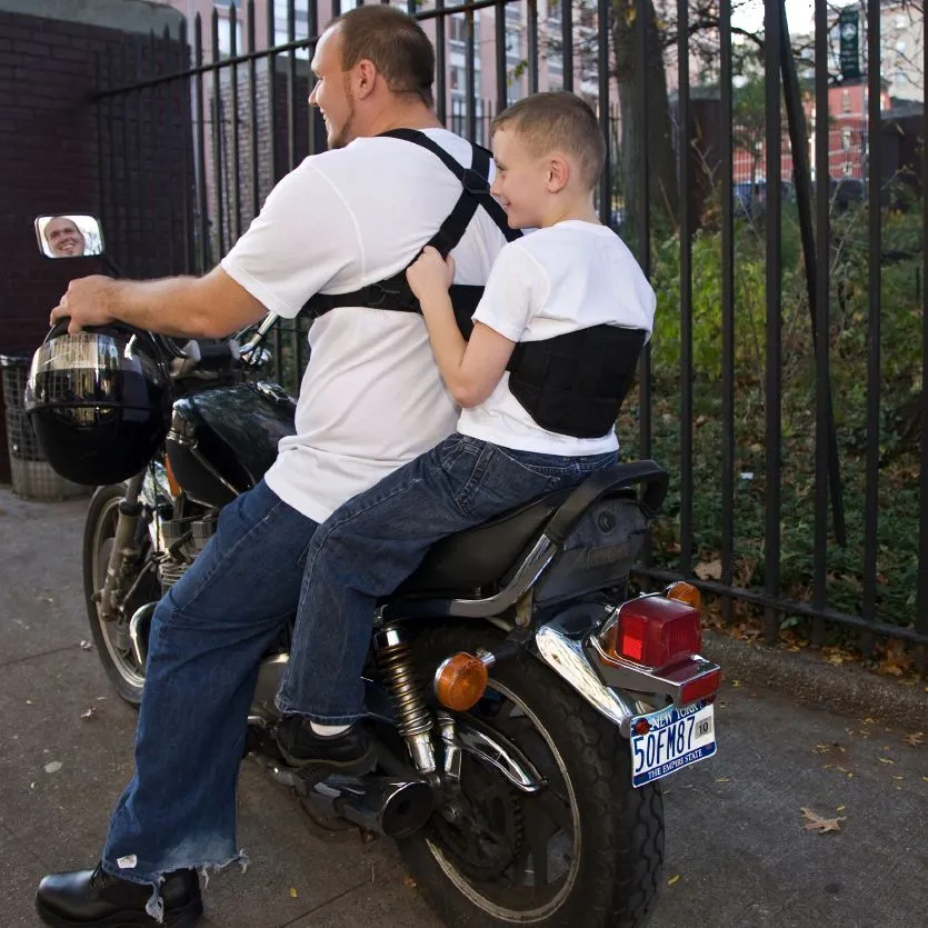 The Moto-Grip (seen here with the Moto-Grip Jr.) is a harness worn by a motorcycle operator, designed to let their passenger hang onto them better