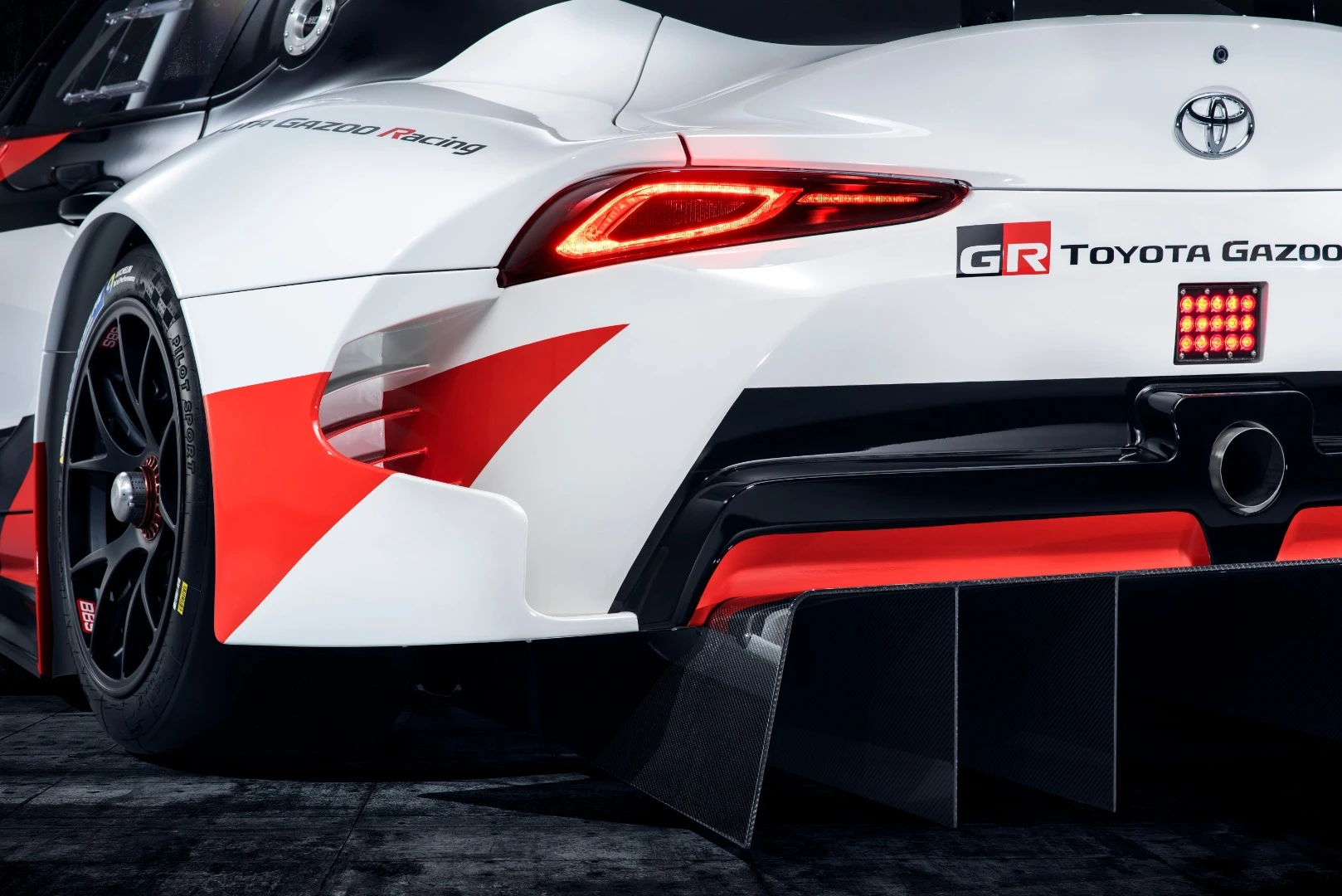The rear of the Toyota GR Supra Racing Concept features brake cooling vents, airflow management ducting, and a sports exhaust