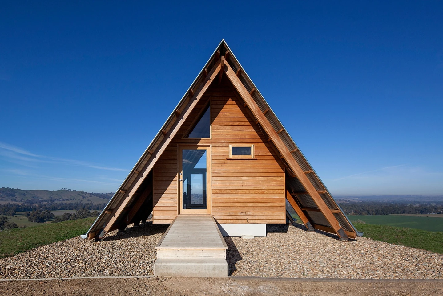 Inside the solar-powered JR's Hut is a bed for two, bathroom with a view and freestanding wood burner fireplace