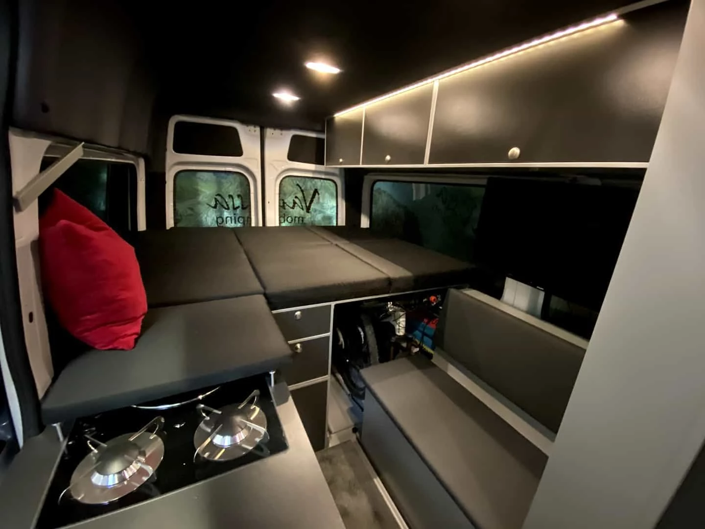 The end panel over the sink/stove combo works with a second end panel on the other side (not shown) to turn transverse bed into longitudinal bed, a simple but convenient solution for getting a little extra foot space