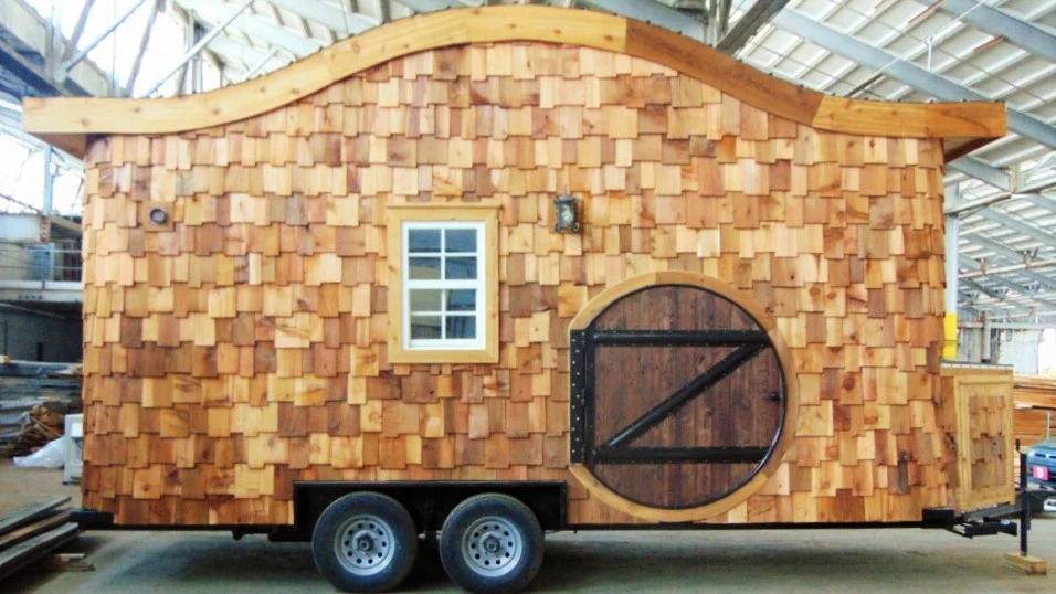 The Hobbit Tiny House sits on a double axle, 20 ft (6 m)-long trailer and comprises a total floorspace of 160 sq ft (14.8 sq m)