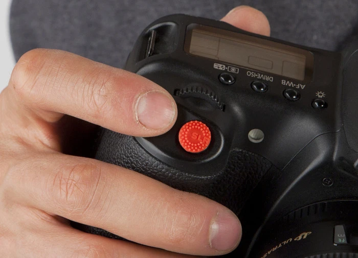 ProDot is an adhesive silicone dot which attaches to the shutter-button of your camera, and is said to make it more tactile