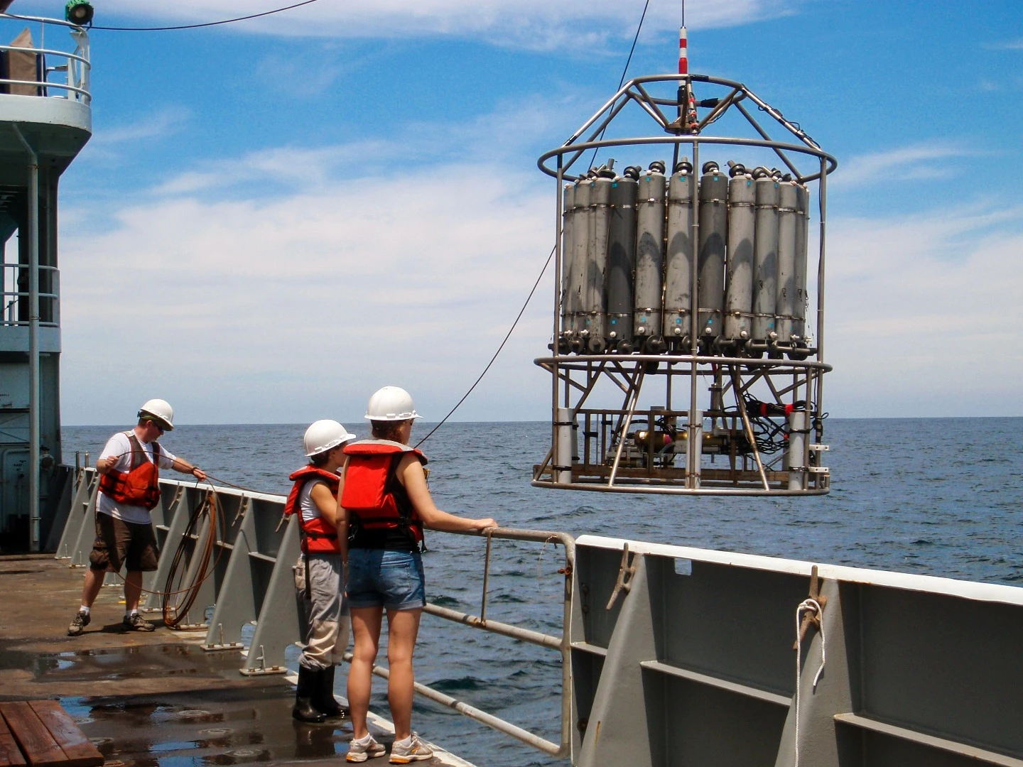 Researchers pictured with one of the sampling devices used to collect readings of the Pacific Ocean