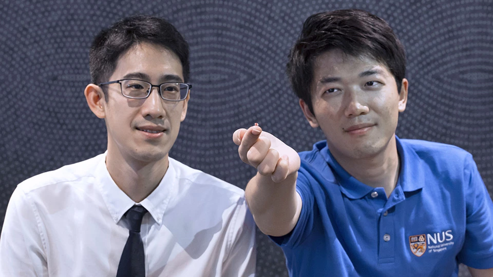 Asst. Prof. John Ho (left) and doctoral student Dong Zhenya, with the biosensor