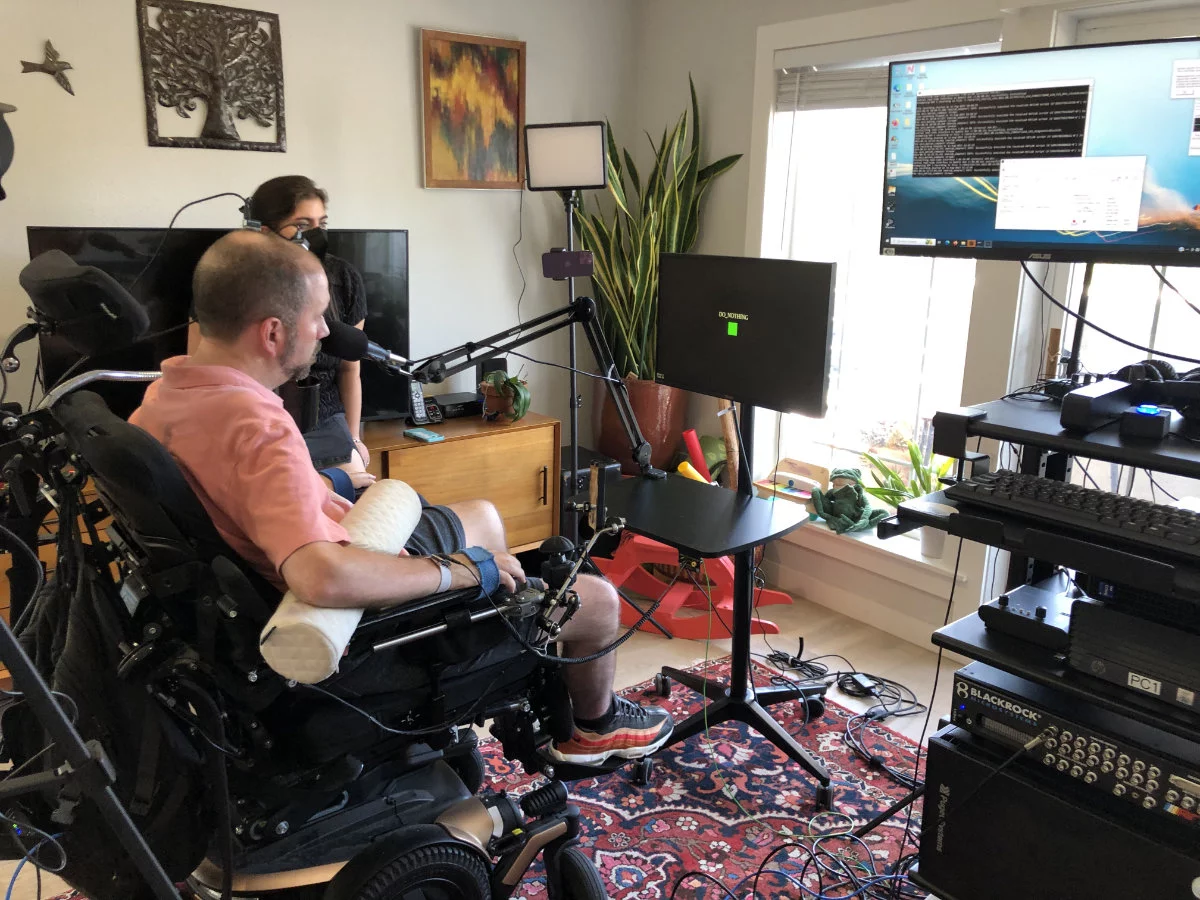 The BCI setup and the study participant using the voice synthesis tech