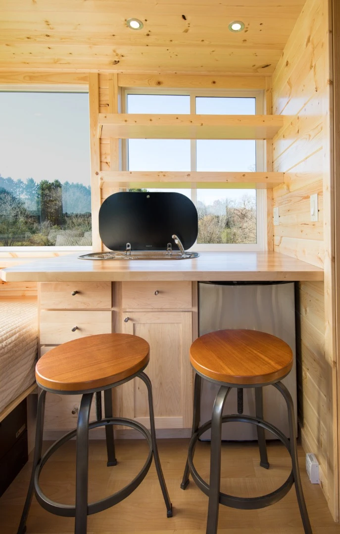 The Vista Sport includes a kitchenette with campervan-style sink and stove, and a refrigerator beneath