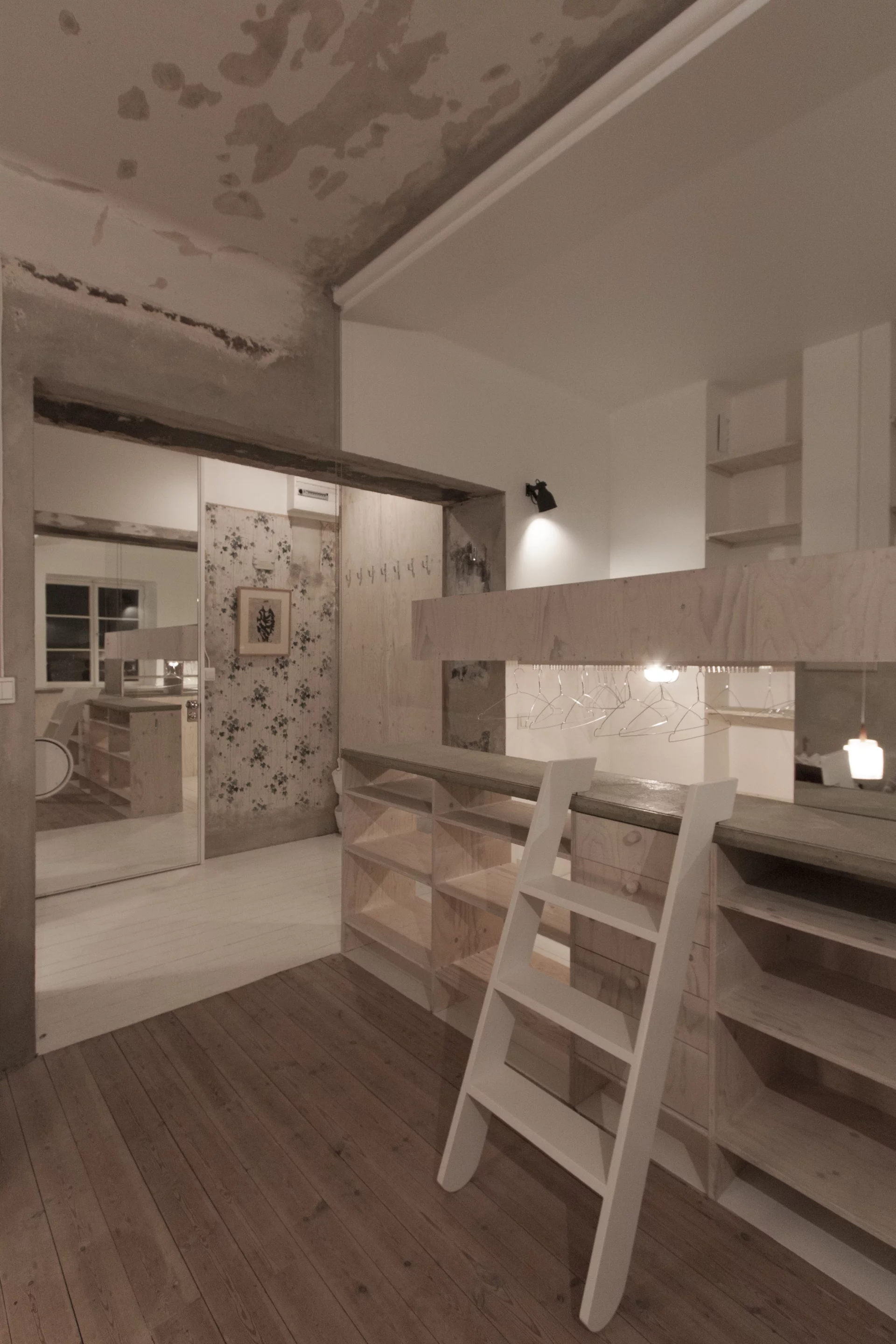 Space saving kitchen/bed/wardrobe zones were made with a single structure