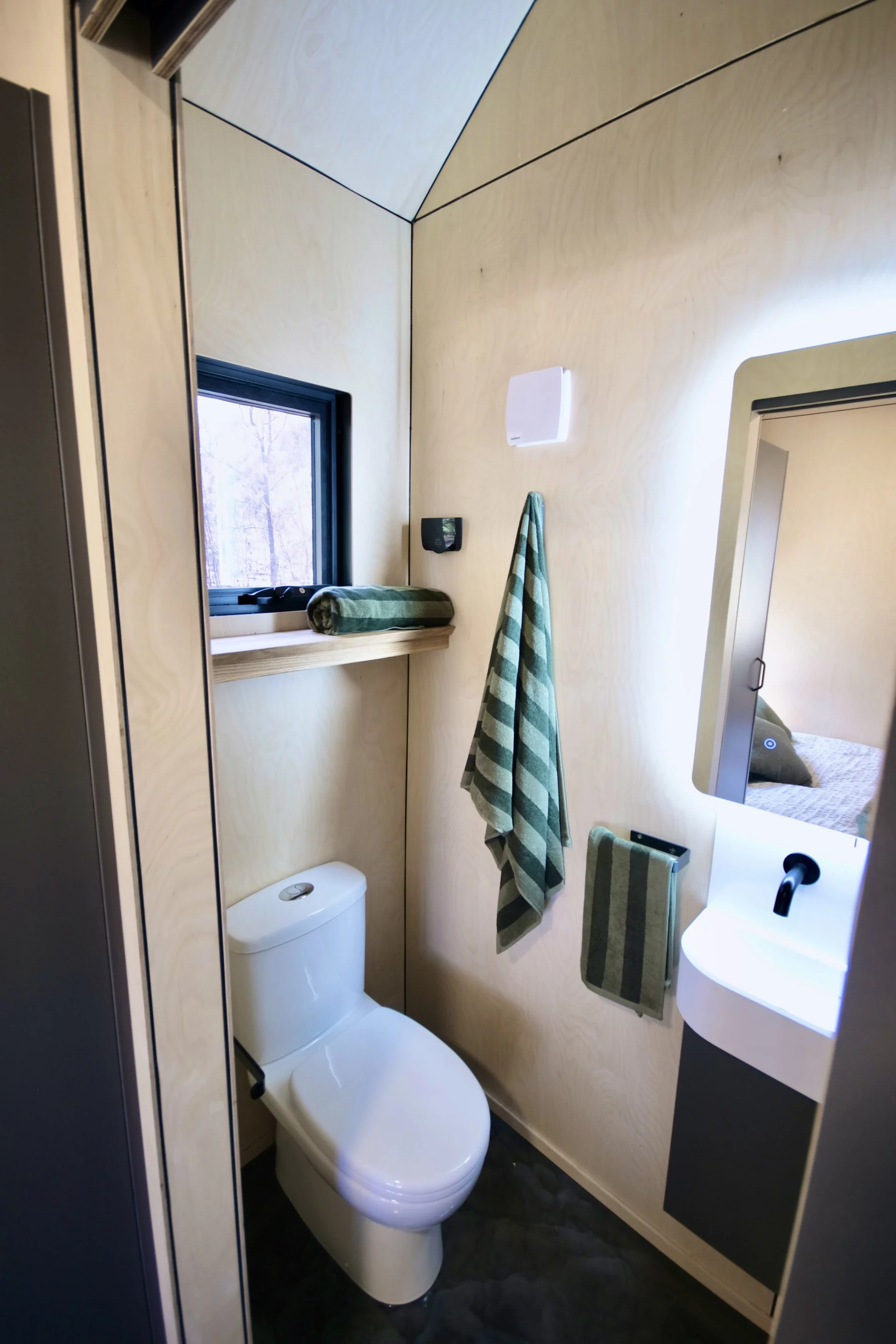 The Eire's bathroom is very compact and includes a flushing toilet, a sink, and a shower