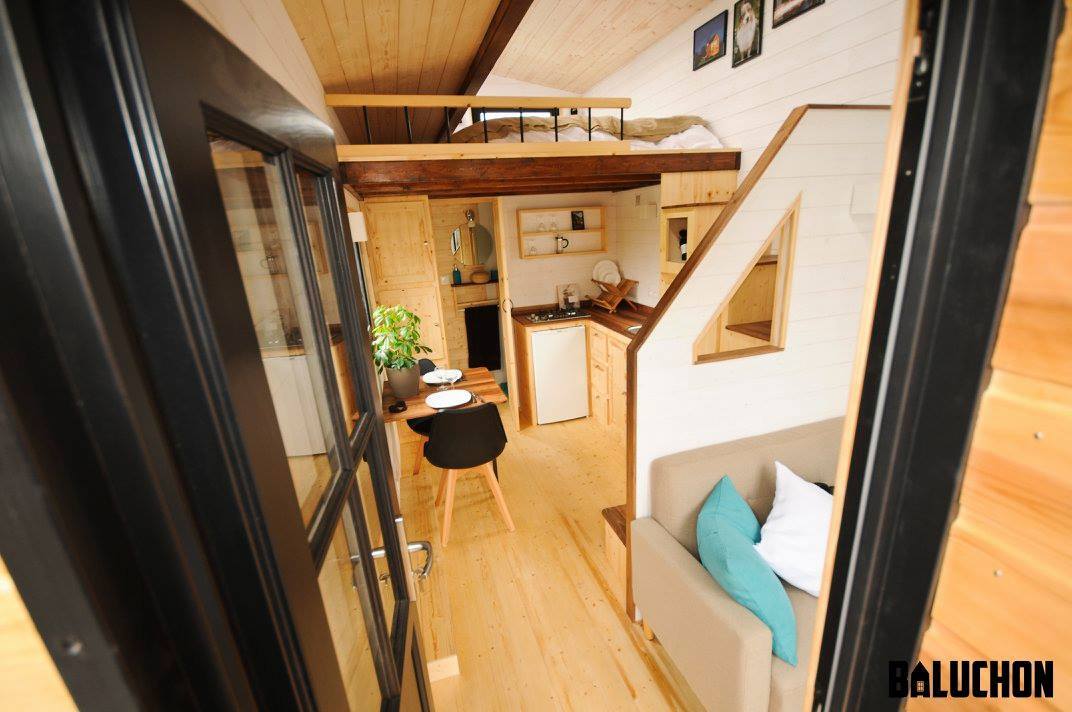 Visitors enter the home through a small covered porch