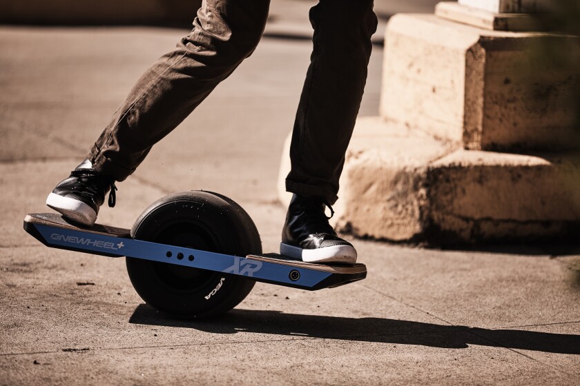 A Onewheel+XR rider leans forward to move and accelerate