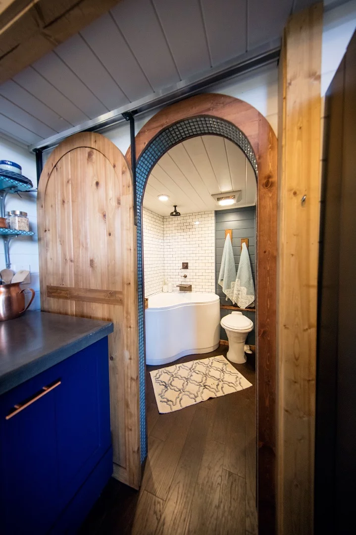 View towards the Tiny Adventure Home's bathroom from the kitchen