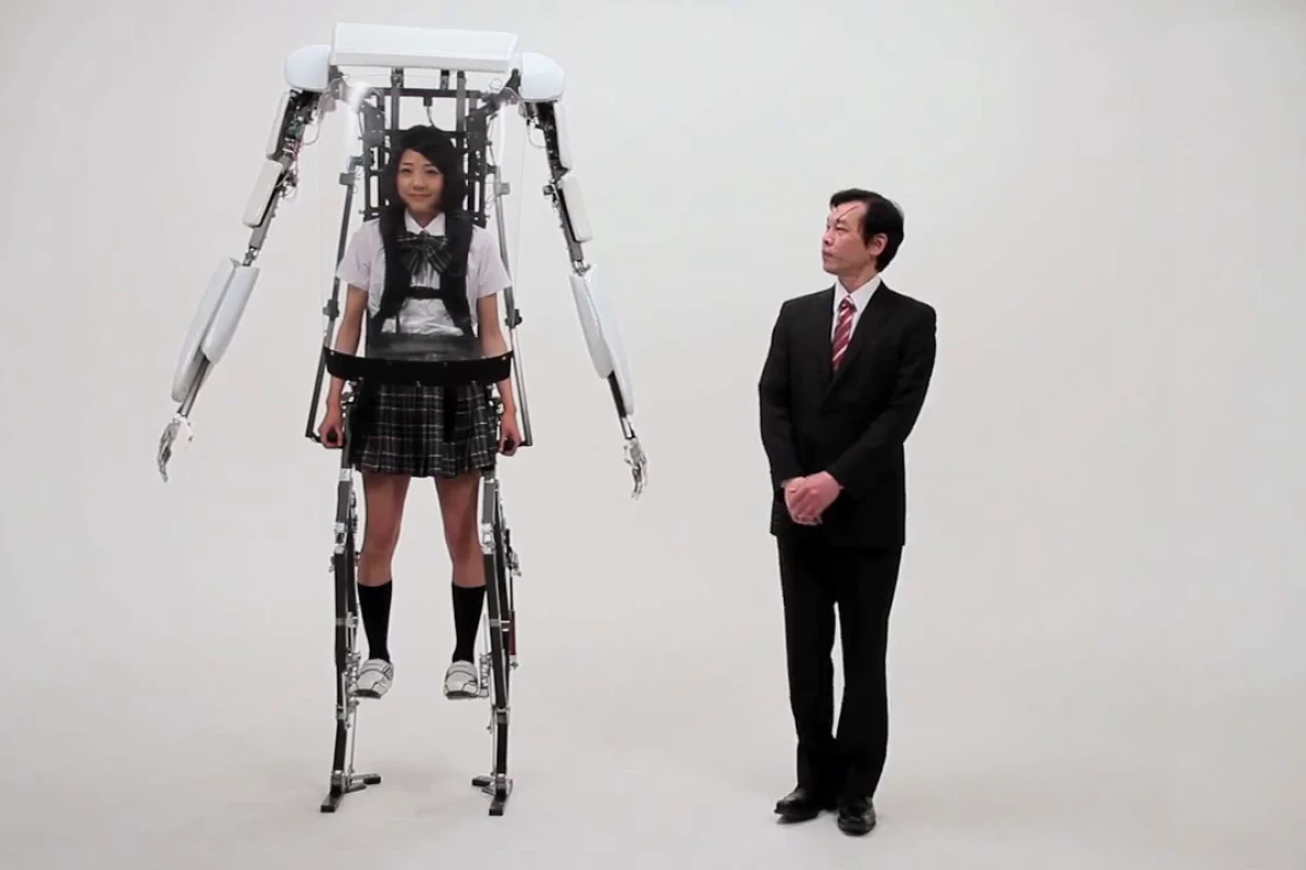 A school girl wearing Sagawa Electronics' Power Jacket MK3 stands above a grown man