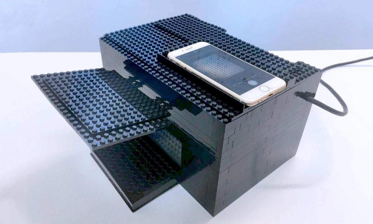 The Lego box is equipped with a UV/vis lamp, a hole for the iPhone camera, and guides for camera and plate placement