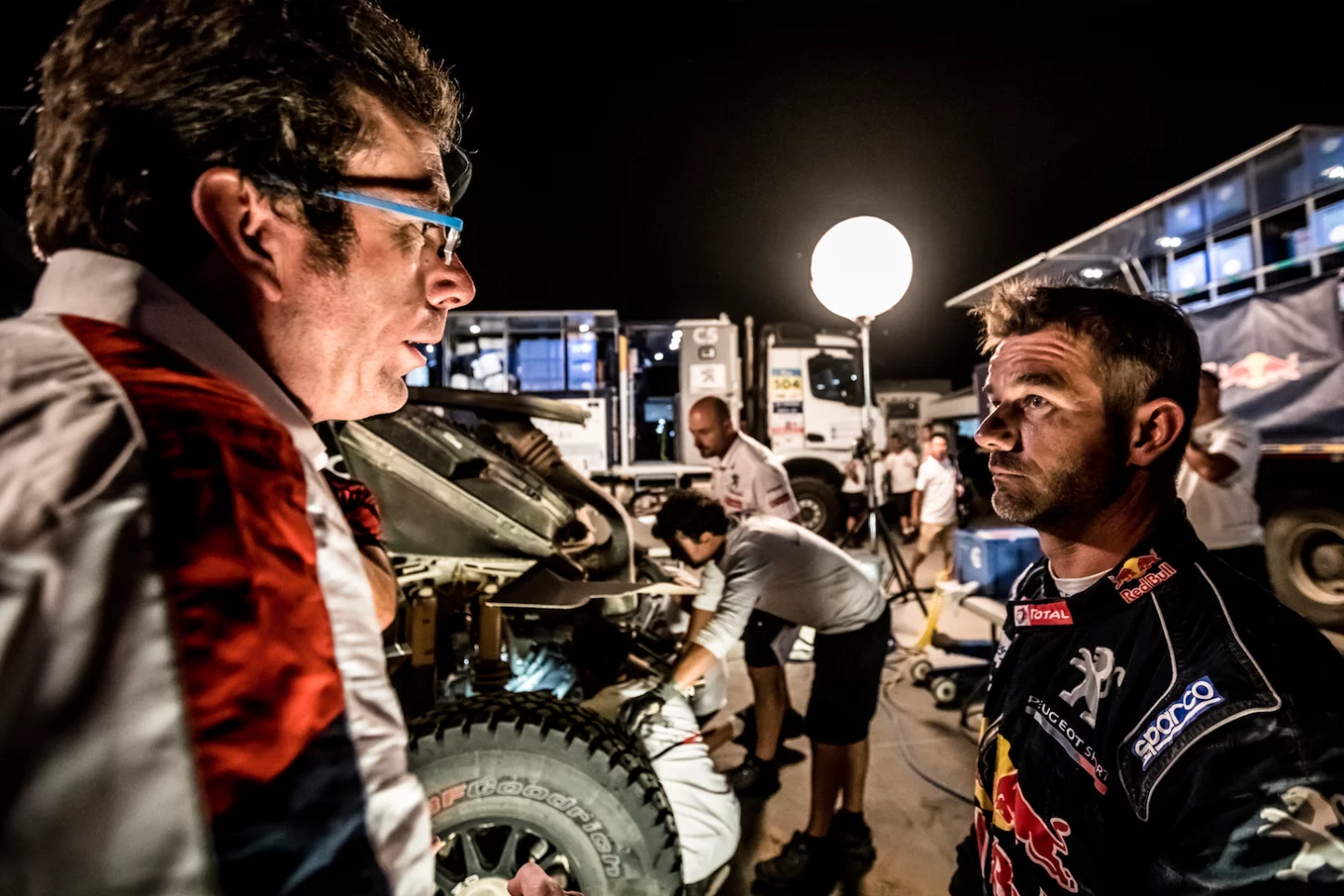 Sebastien Loeb in front of his battered Peugeot 3008DKR Maxi