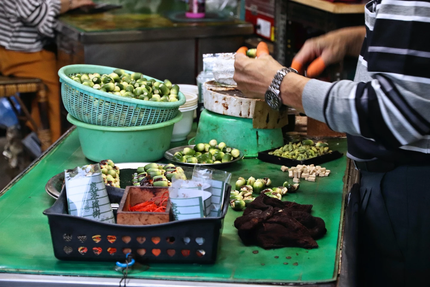 A street vendor in Taiwan prepares betel nuts for sale