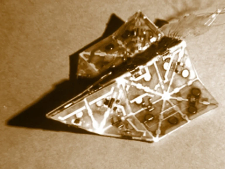 Studded with magnets and electronic muscles known as actuators, a prototype robot developed at MIT can automatically fold itself into an airplane or an origami boat