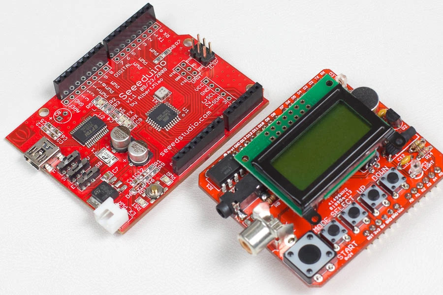 An Arduino clone made by Seed studios (left), and the Triggertrap Shield with the screen mounted