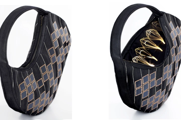 The Solar Handbag has solar cells on the outside and a battery and optical fiber lighting on the inside