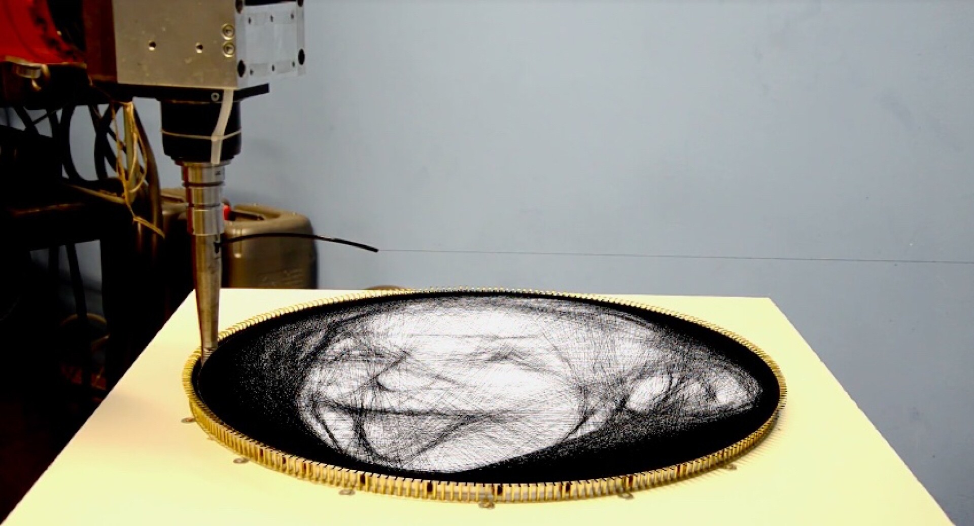 Artsy robot reproduces images by winding thread