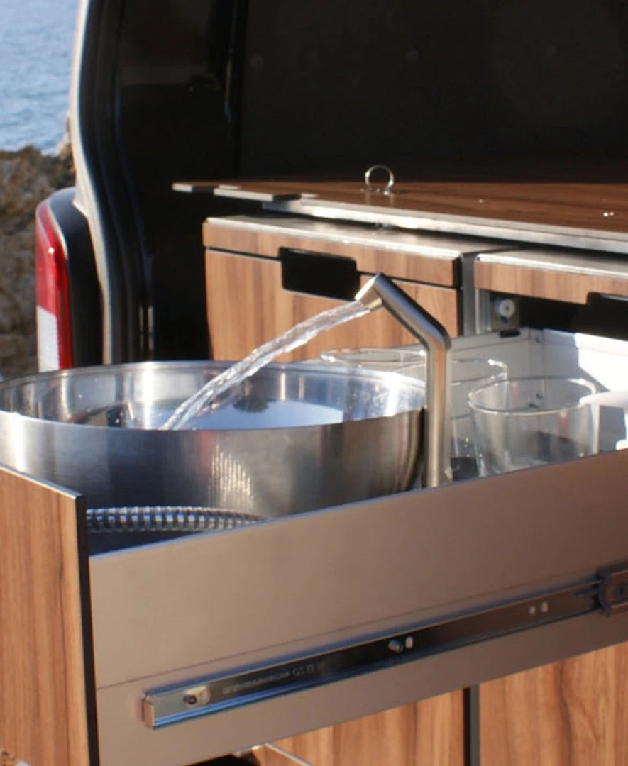 The wash module includes both a sink and a sprayer hose