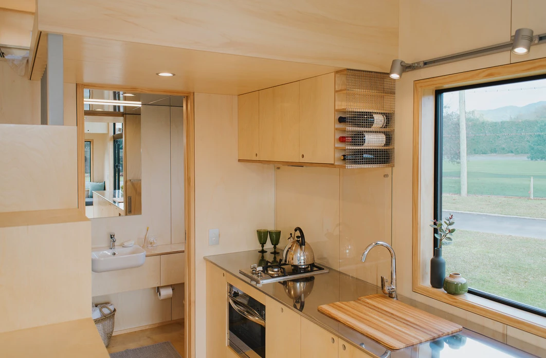 The First Light Tiny House's kitchen includes a large counter finished in stainless steel