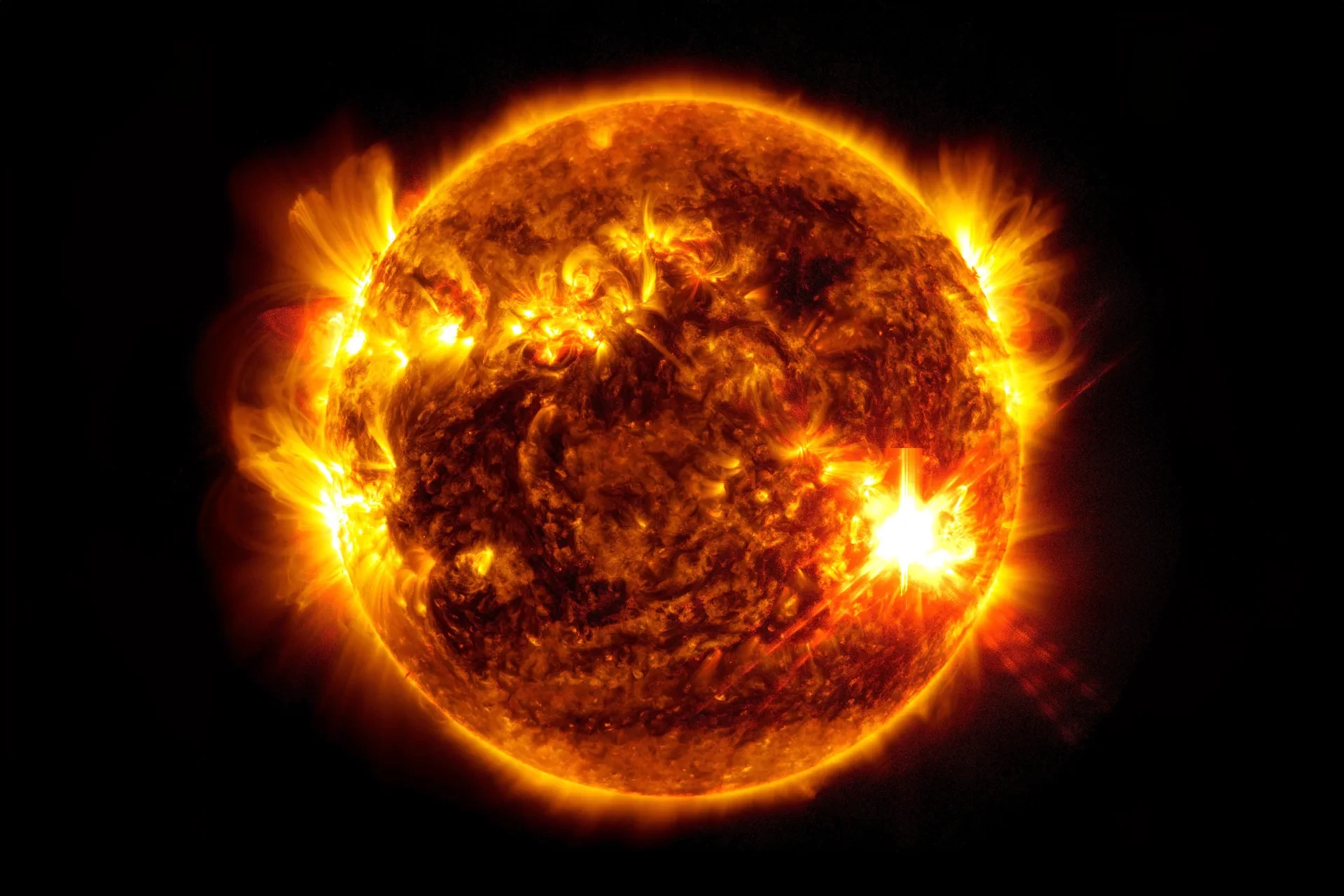 The extremely bright area at about 4 o'clock shows a solar flare from May 10 rated at X5.8. The image is rendered in a subset of extreme ultraviolet light.