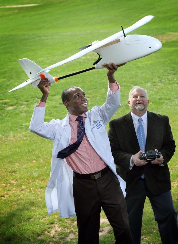 Dr. Timothy Amukele (left) with colleague Robert Chalmer