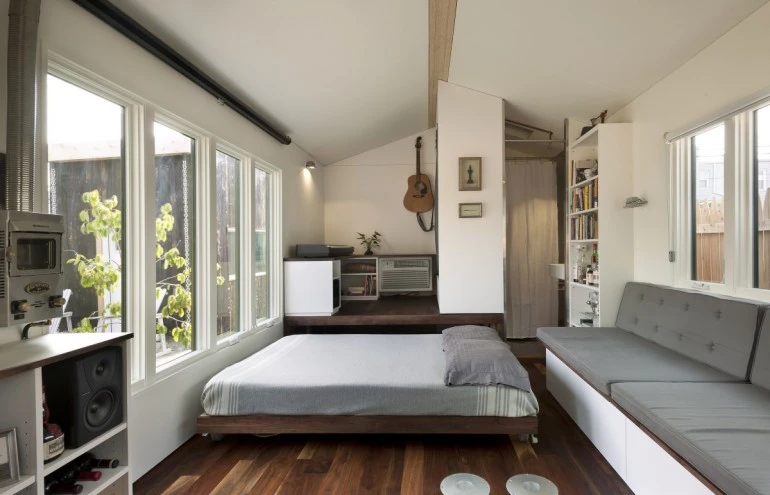 The interior also boasts multi-use surfaces, refrigerator, and ample storage space (Photo: Paul Burk Photography)