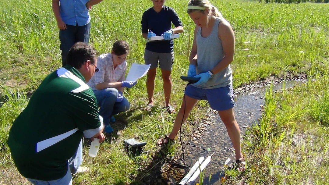 Students test the conditions of water for traces of GMO proteins, using Rice University's Star Trek-inspired device