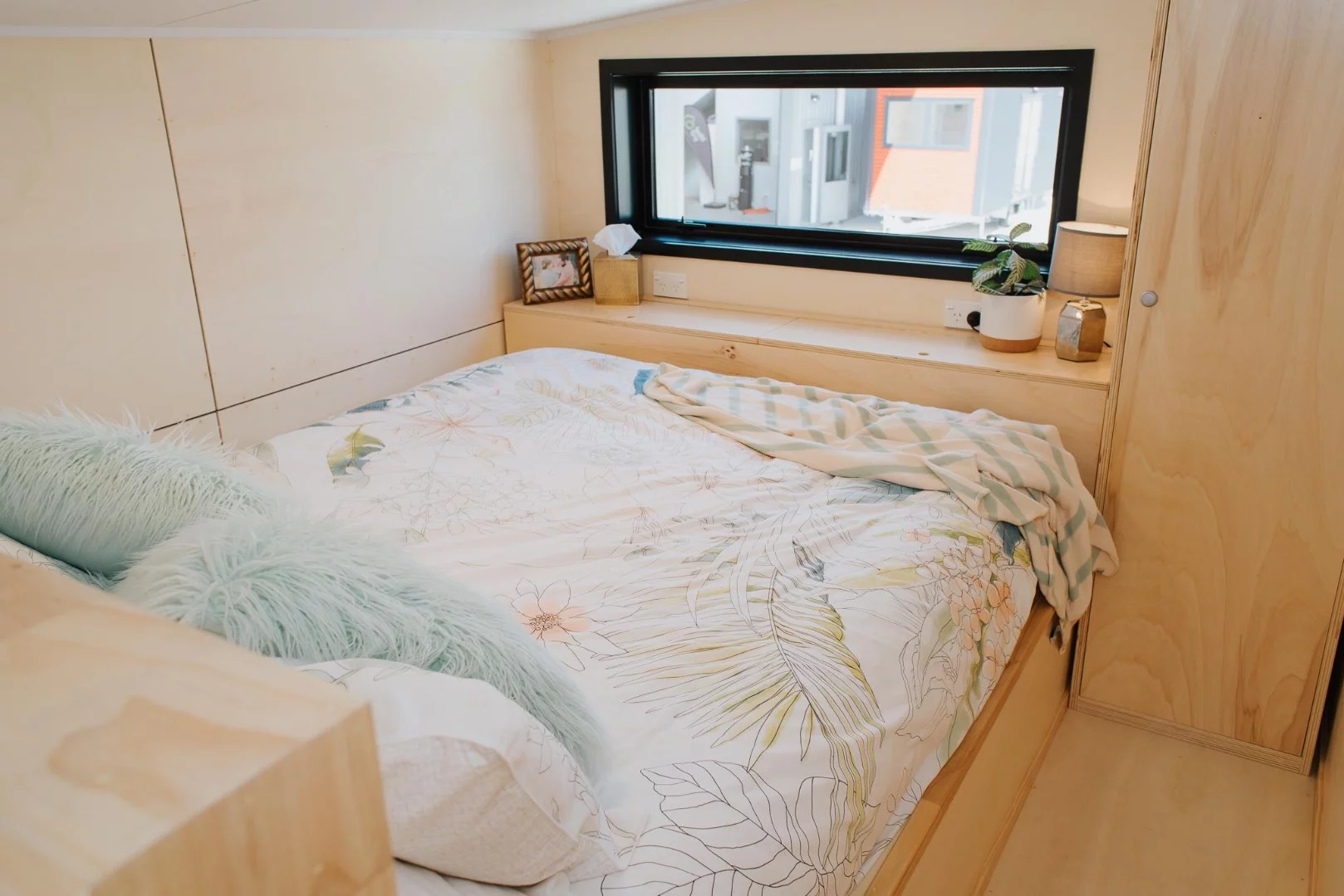 La Sombra Tiny House's main bedroom includes a queen-sized bed