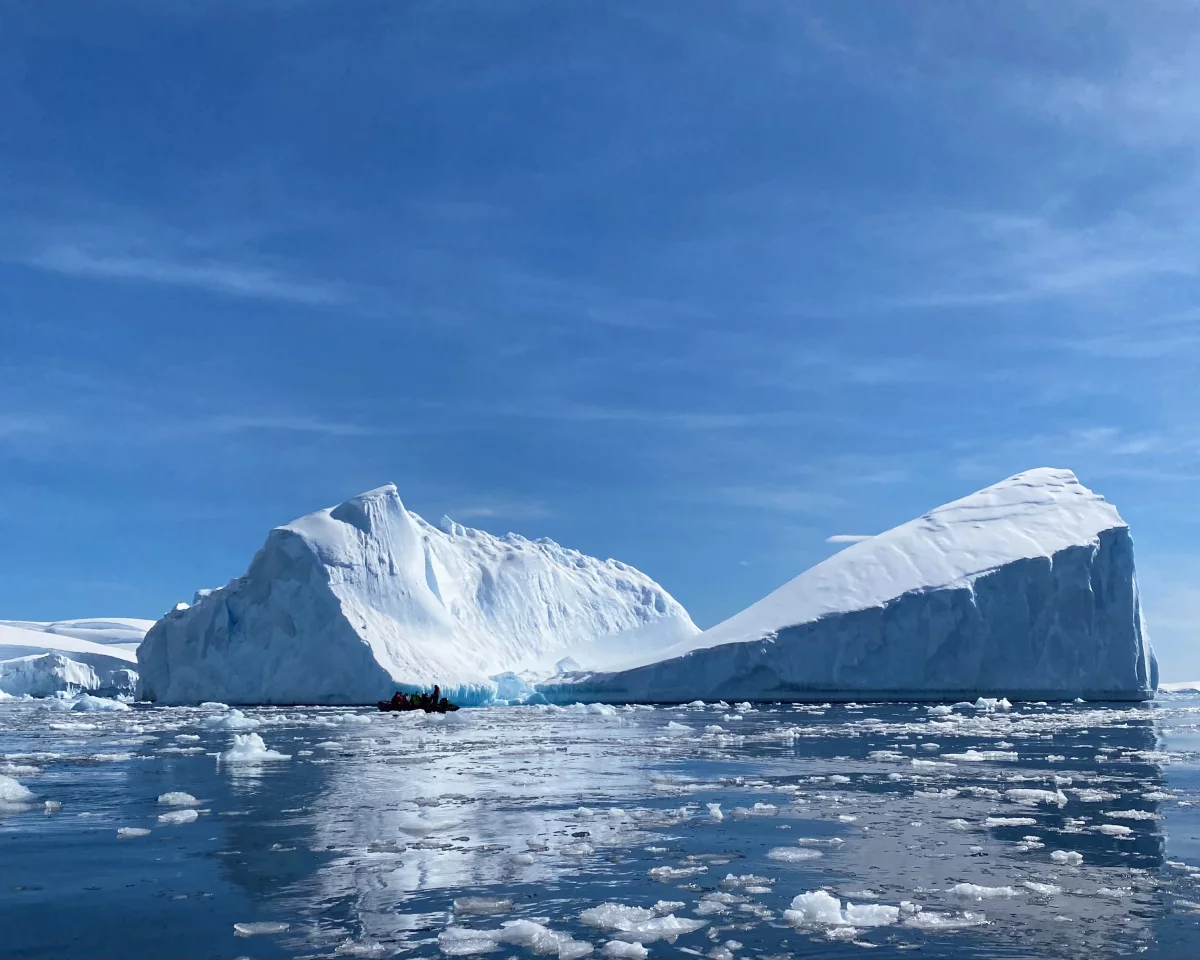 Large iceberg with a ‘zodiac’ boat for scale at Fournier Bay