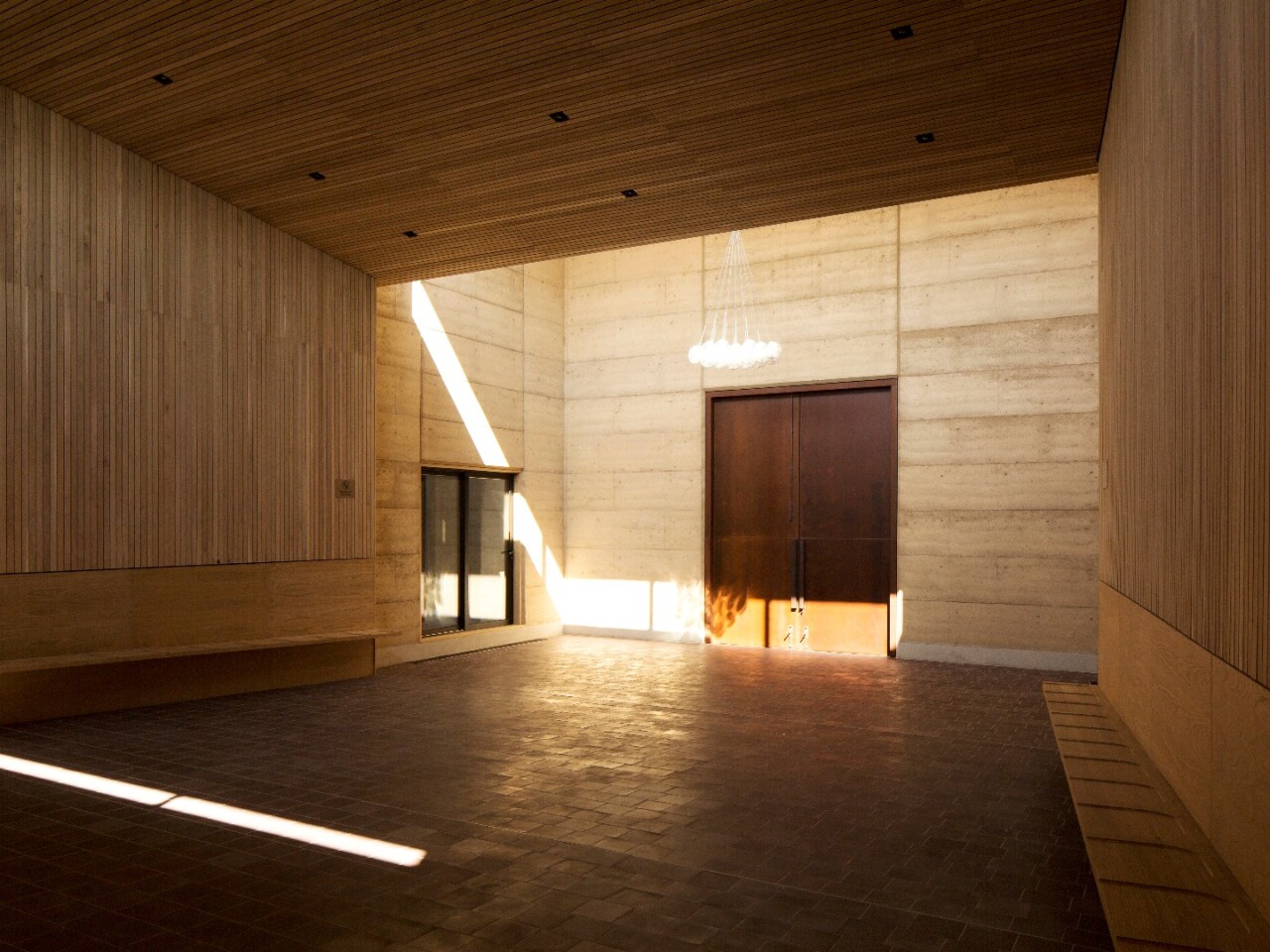 Rammed earth walls surround the prayer hall at the Bushey Cemetery, by Waugh Thistleton Architect