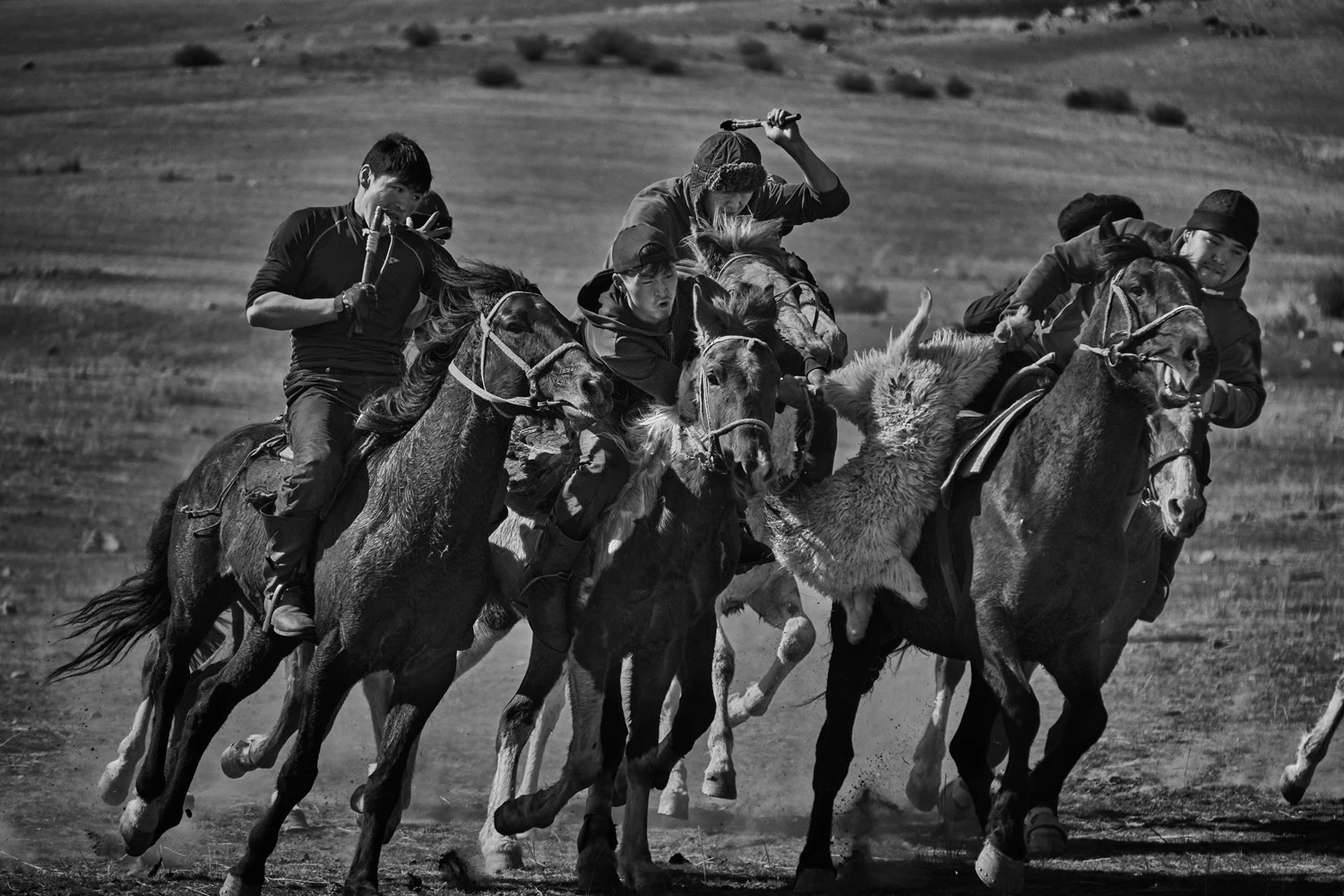 PEOPLE OF THE WORLD PORTFOLIOHIGHLY COMMENDED: Alain Schroeder, BelgiumTalas, Taldy-Bulak, KyrgyzstanTrying to outrun your opponents with a decapitated goat wedged between your leg and your horse, might not be your idea of a fun game, but in Kyrgyzstan, Kok Boru is the national sport. Dead goat polo feels more to me like cavalier rugby. Organized in two teams of five, but sometimes many more, riders race from one end of the field to the other chasing the rider with the goat whose sole intention is to score a point by heaving the 20 kilo body into the Tai Kazan (goal) on either end.Fujifilm X-Pro2, 148mm lens, f5, 1/2700 sec, ISO 800
