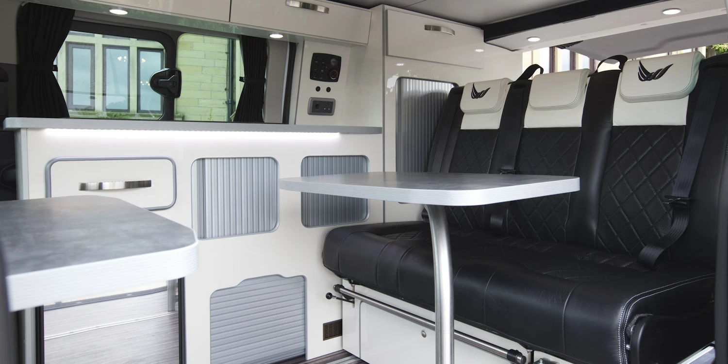 The interior offers a kitchen, dining area and beds
