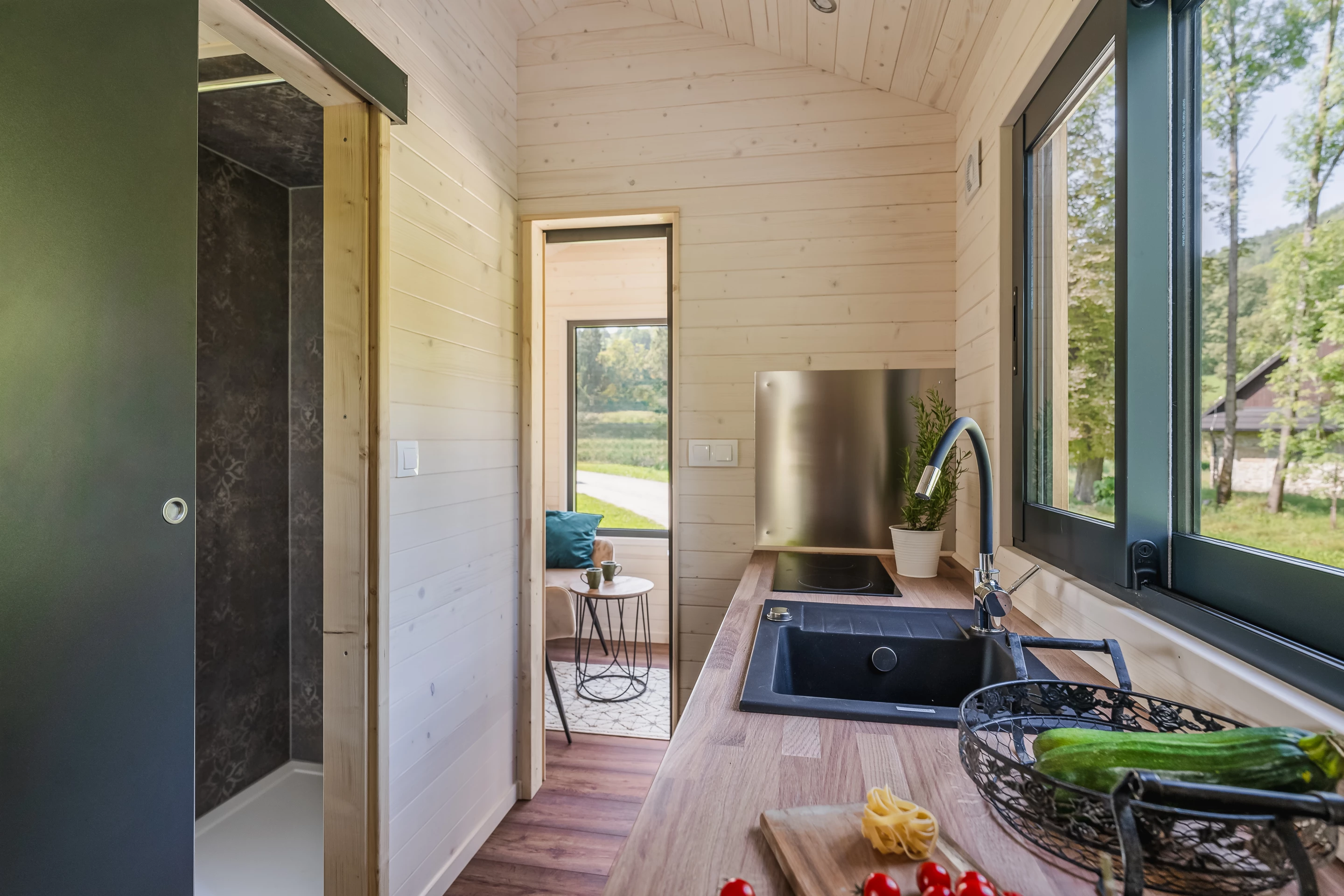 The Kangourou's kitchen is quite small and has a sink, an induction cooktop, a built-in fridge and cabinetry