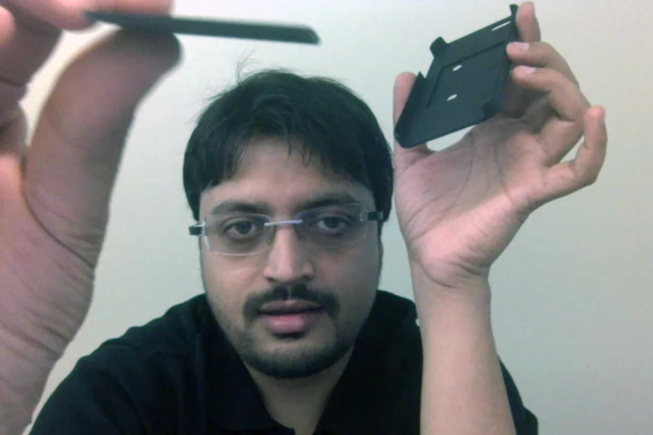Hamish Patel shows the modular electronics module which fits inside the Wello health monitoring iPhone case