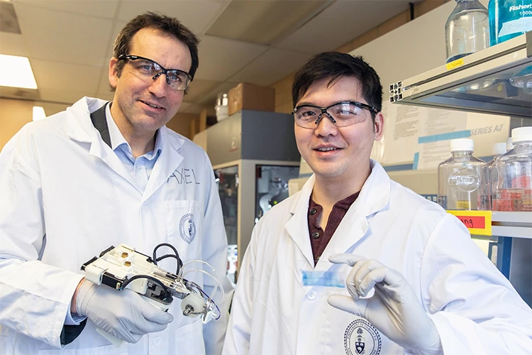 Associate Professor Axel Guenther and PhD candidate Richard Cheng with their bioprinter to treat severe burns