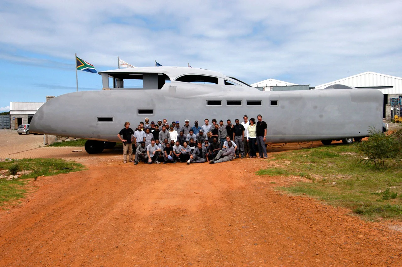 Tag employees dwarfed by Tang's hull
