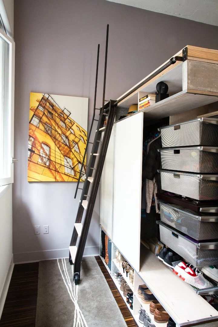 The master sleeping space is accessed via a sliding library ladder