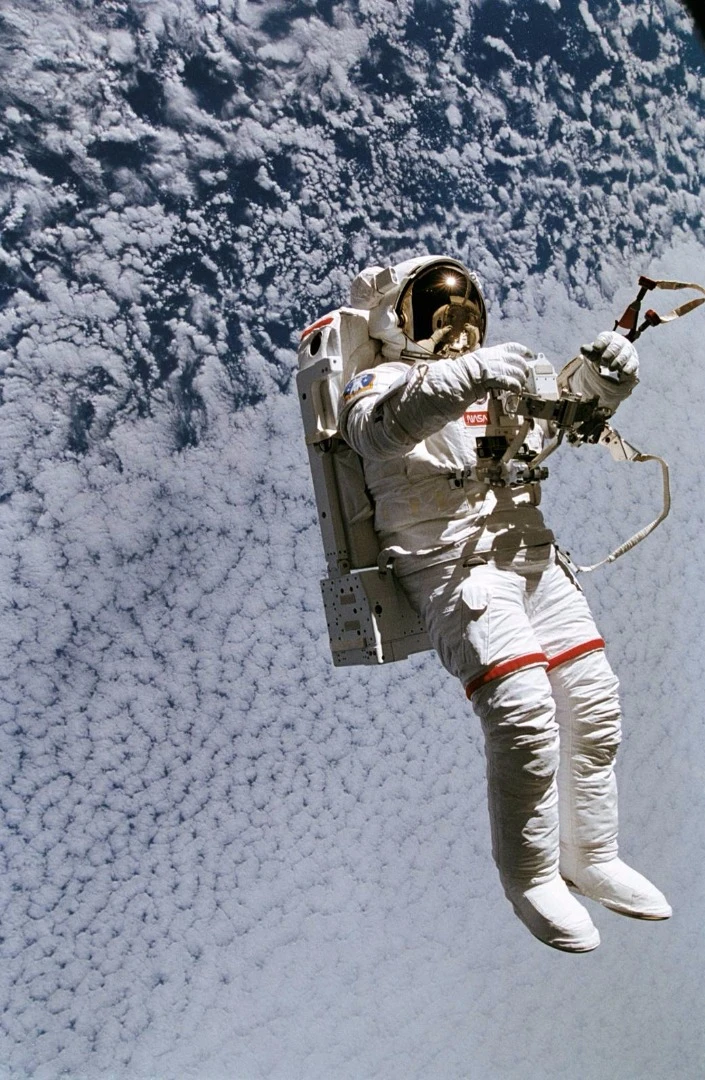 Astronaut Mark C. Lee floats freely as he tests the new Simplified Aid for EVA Rescue (SAFER) system, intended to be used to emergencies only