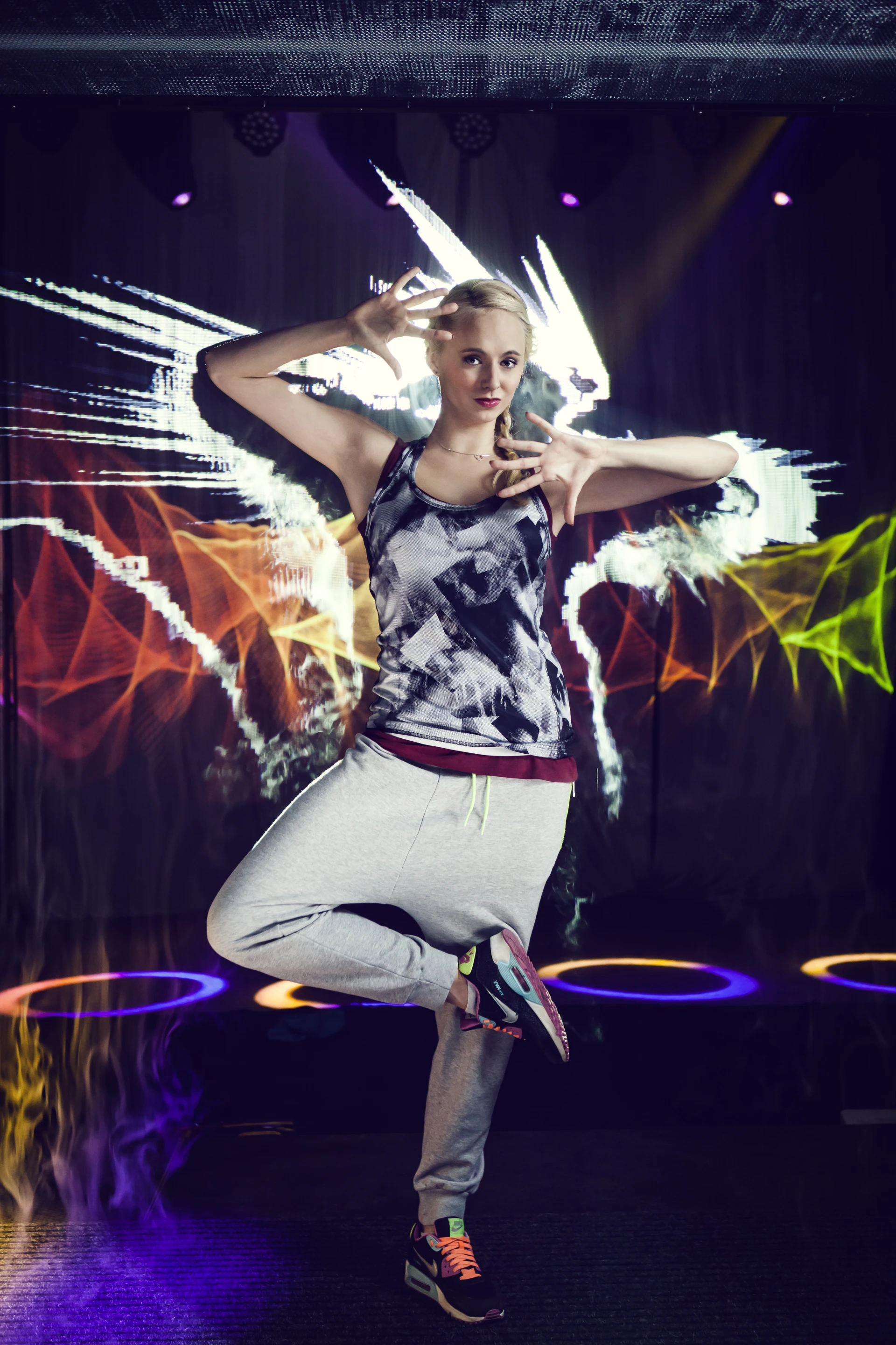 A young woman manipulating the mist and dancing within the display
