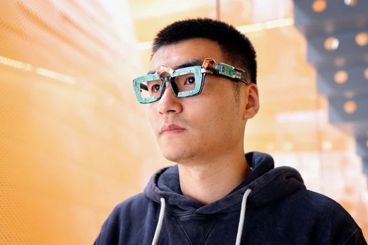 Head scientist Ke Li models prototype glasses equipped with both the GazeTrak and EyeEcho systems