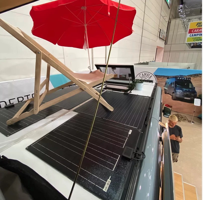 Camper Schmiede installs a rooftop terrace with walkable solar panels and a quick-access hatch from inside