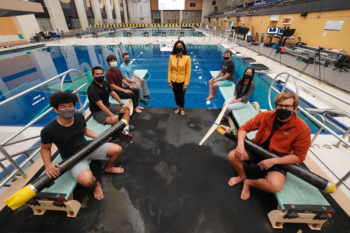 Assoc. Prof. Nina Mahmoudian (center) and her student team, with a couple of ROUGHIE prototypes