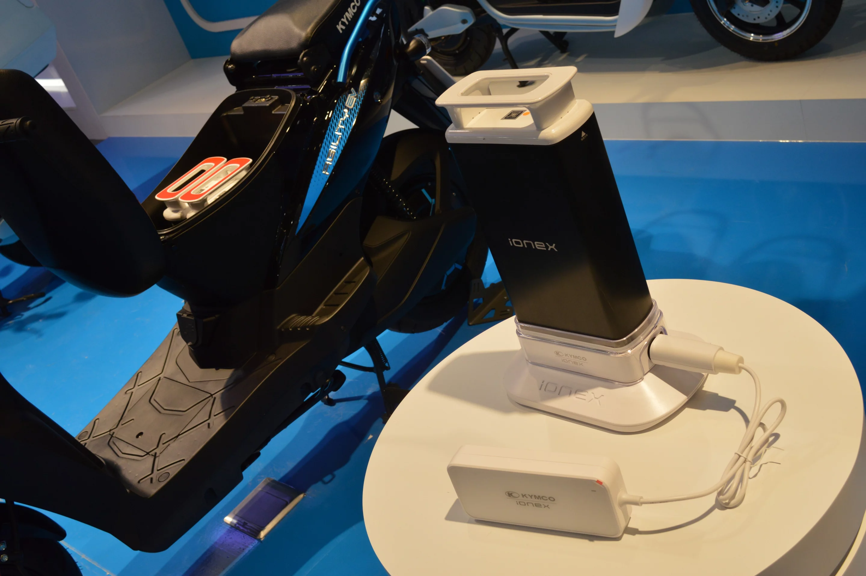 A Kymco Ionex battery charging on a portable power bank