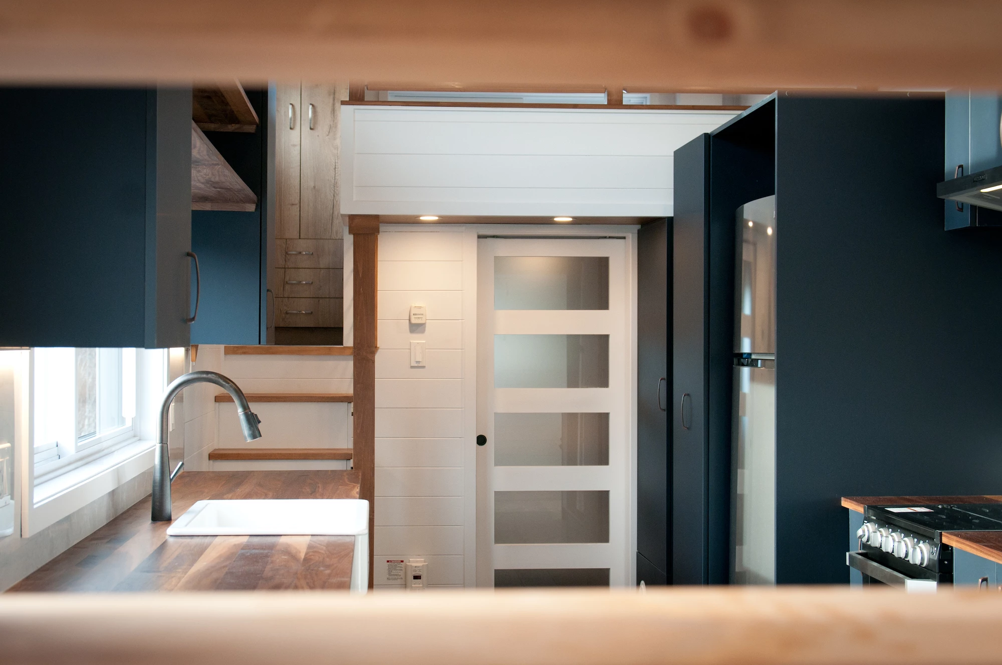 The Charme V2's kitchen features long walnut countertops