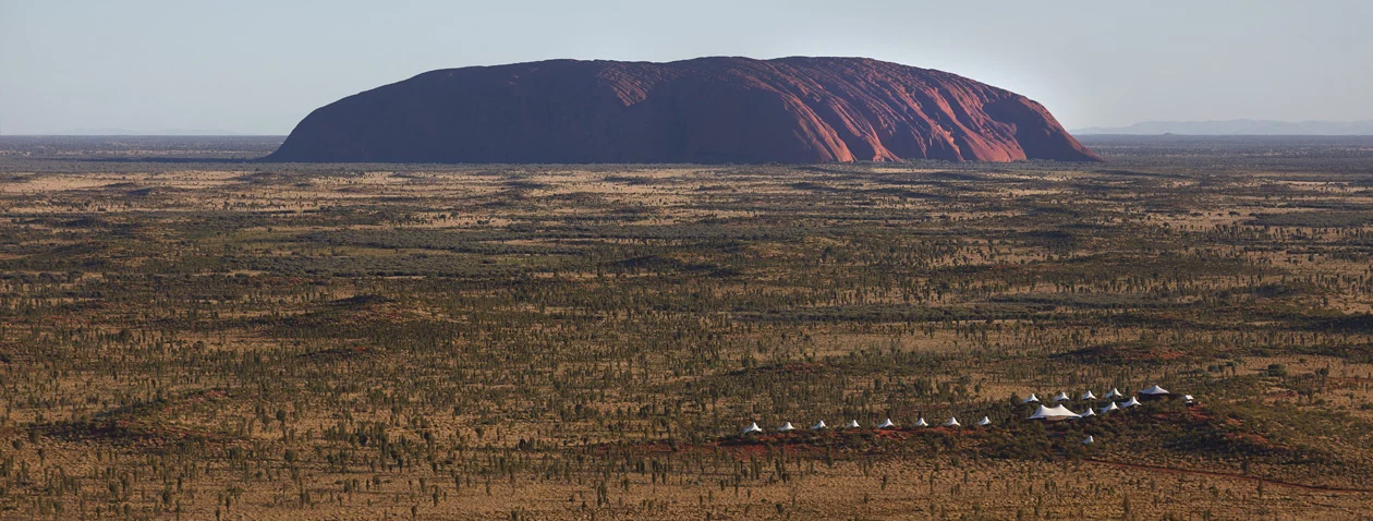 In the center of Australia you’ll find the gigantic and iconic Uluru, and facing it is a luxury hotel called Longitude 131. For those inclined you can helicopter from the local airport to the hotel