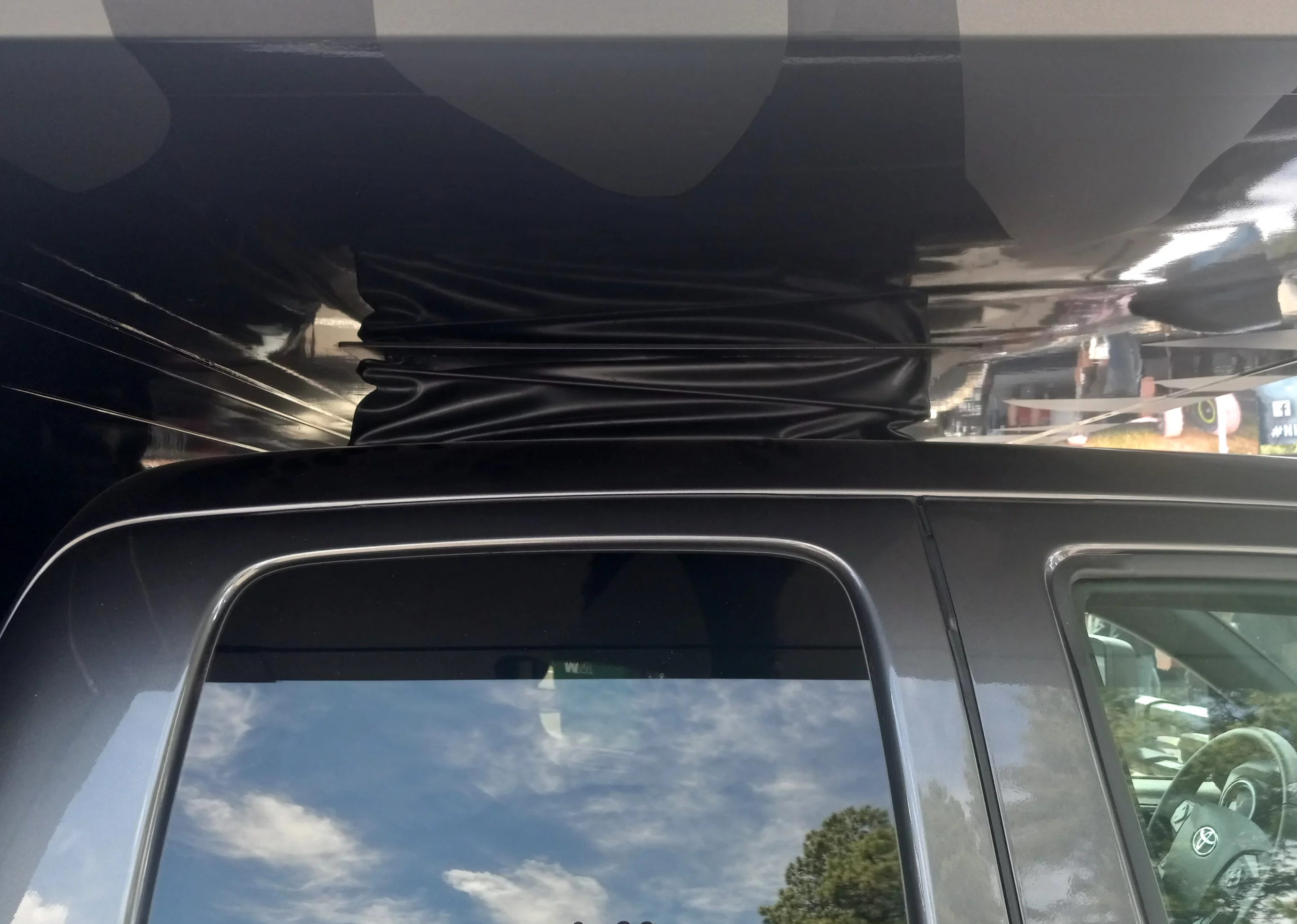 World Travel Vehicles cuts a hole in the Tacoma cab and seats a gasket in to provide full weather protection in its alcove-to-cab pass-through